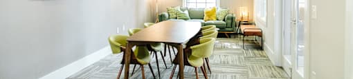 A dining room with a round table and chairs.