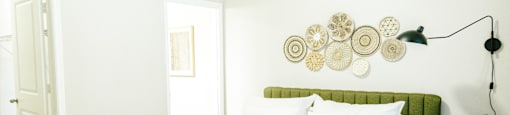 A bedroom with a bed, nightstand, and lamp.