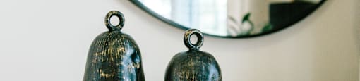 two bells sitting on top of a stack of books on a table at Tapestry at Hollingsworth Park