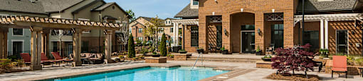 A large house with a pool in front.