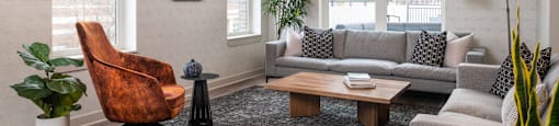 a living room with couches and chairs and a table
