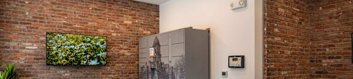 a room with a refrigerator and a brick wall