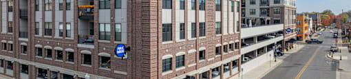 A street view of a building with a blue sign on it.