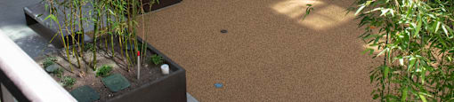 A courtyard with a cork floor and a few trees.