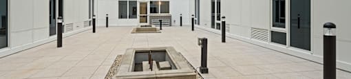 A courtyard with a fountain in the middle of it.