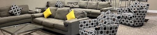 a living room with couches and chairs and a table