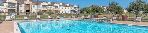 A swimming pool in front of a residential building.
