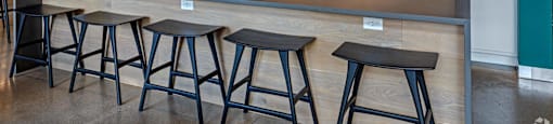 a kitchen with a counter and bar stools