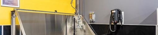 a stainless steel sink in a kitchen with a phone