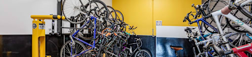 a group of bikes hanging on a wall in a room
