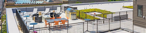 the terrace of a building with tables and chairs on top of a roof