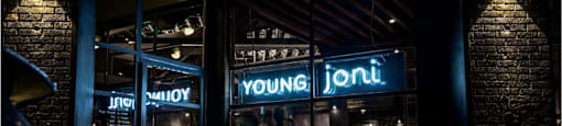 a restaurant at night with a neon sign in the window