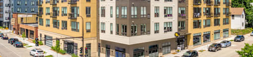 a rendering of a new apartment building on the corner of a city street