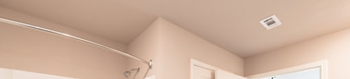A white bathroom with a tub and a door.