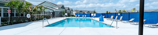 A pool with chairs and an umbrella