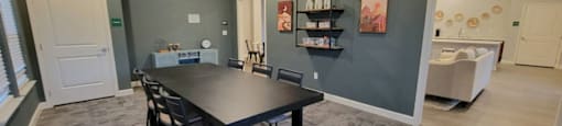 room with a table and chairs with wall decorations at Agave East Apartments