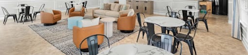 A spacious living room with a variety of seating options and a marble table.