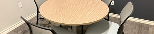 A round table with four chairs around it.