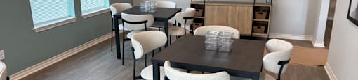 A dining room with a table and chairs.