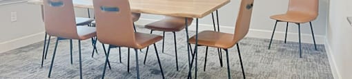 A conference room with a table and chairs.