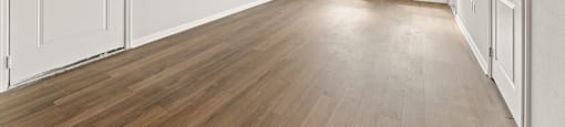 A room with wooden floors and white walls.