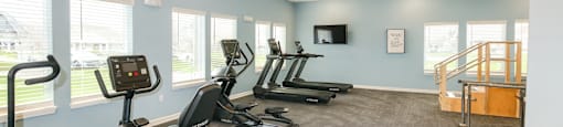 A spacious gym with a variety of exercise equipment.