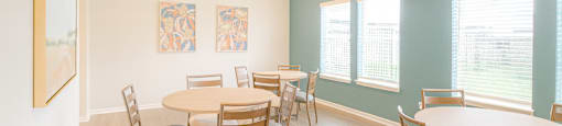 A room with a table and chairs.