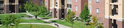 A large apartment complex with a grassy courtyard in the middle.