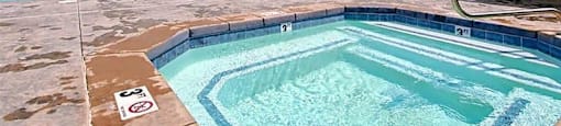 A pool with a mountain view in the background.