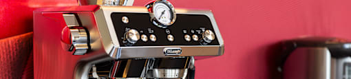 a espresso machine on a counter with a cup of coffee at Analog PDX Apartments, Portland