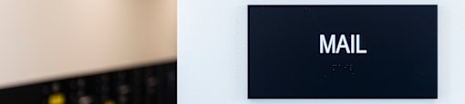 a sign for a mall on a white wall at Analog PDX Apartments, Oregon 97227
