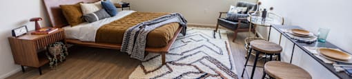 a bedroom with a bed and a desk and a window at Analog PDX Apartments, Oregon