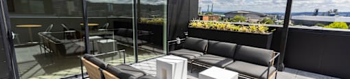 a large patio with couches and tables on a roof at Analog PDX Apartments, Oregon 97227