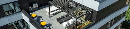 a large building with a rooftop terrace on top of it at Analog PDX Apartments, Oregon 97227