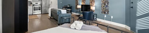 a bedroom with a bed and a living room