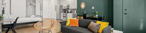 a living room with a couch and a table and a kitchen