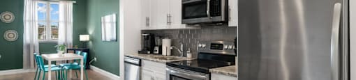 a kitchen with stainless steel appliances and a stainless steel refrigerator