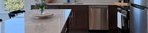A modern kitchen with a window and a wooden counter.