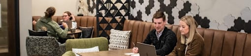 A group of people are sitting at a table in a restaurant.