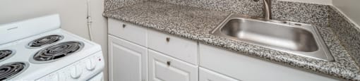 Kitchen with white cabinets and sleek countertops 1170 N Logan St in Denver, CO