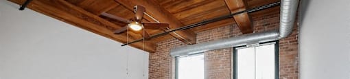 Spacious living area with stunning brick wallsat Carriage House Lofts, Chicago, IL