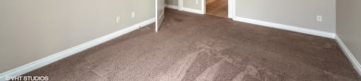 Bedroom with plush carpeting and a private bathroom