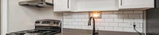 Renovated kitchen with subway tile backsplash at 1303 Columbine in Denver, CO