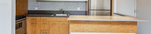 Chic accents in the upgraded kitchen including pendant lighting over the breakfast bar at Metropolis in Denver, CO