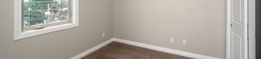 Bedroom with plush carpeting and lots of natural lighting