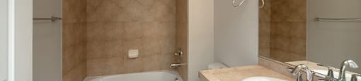 Bathroom with a full tub and vanity storage