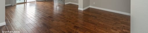 Living room with rich wood flooring and private balcony access