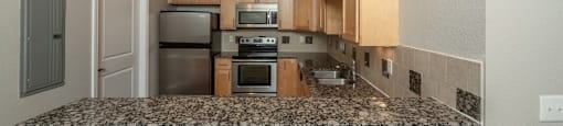 Rich wood cabinets and a glass top stove