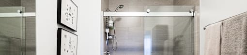 Tiled shower with glass enclosure at Broadway Place