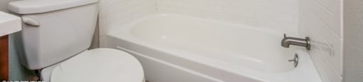 Bright bathroom with tiled tub surround